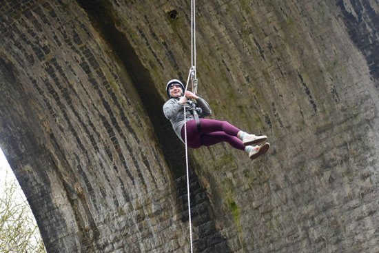 Blue Peter presenter Abby Cook abseiling at Millers Dale