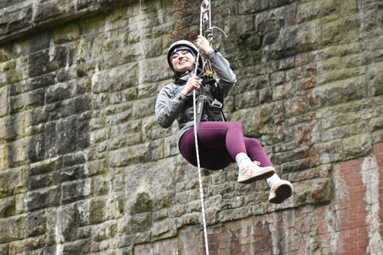 Blue Peter presenter Abby Cook abseiling at Millers Dale